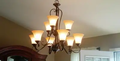 Classic ceiling chandelier installation with warm lighting in San Diego, CA