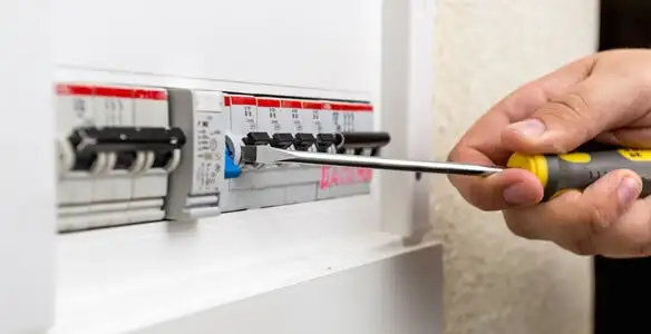 electrical panel upgrade service showing technician adjusting circuit breakers during system upgrade in San Diego, CA
