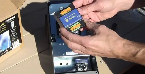 Electrician installing whole home surge protection unit inside main electrical panel in San Diego, CA
