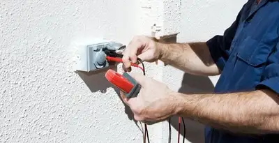 Electrician performing home electrical outlet and wiring inspection in San Diego, CA