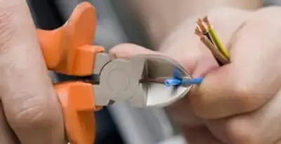 professional electrical services showing precise wire cutting by licensed electricians in San Diego, CA