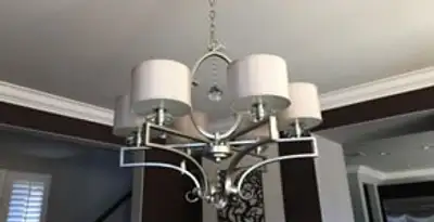 Modern chandelier installation with multiple light fixtures in San Diego, CA