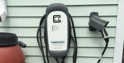 Outdoor electric vehicle charger installation on residential wall in San Diego, CA